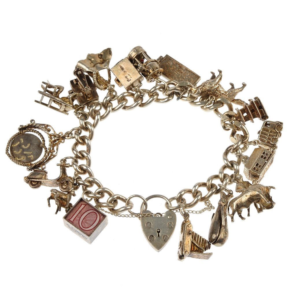 Two silver charm bracelets.: Two silver curb-link charm bracelets, suspending twelve charms and sixteen charms, to include a faceted paste egg timer charm. Twelve charms and two bracelets with marks indicating silver. Total weigh
