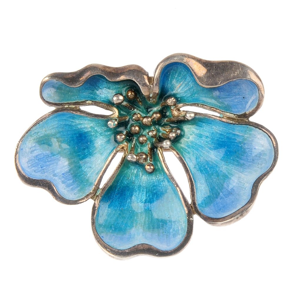 NORMAN GRANT - a silver enamel floral brooch.: NORMAN GRANT - a silver enamel brooch, designed as a stylised flower, with blue and green enamel. Hallmarks for Edinburgh, 1983. Length 3.4cms. Weight 7.9gms.