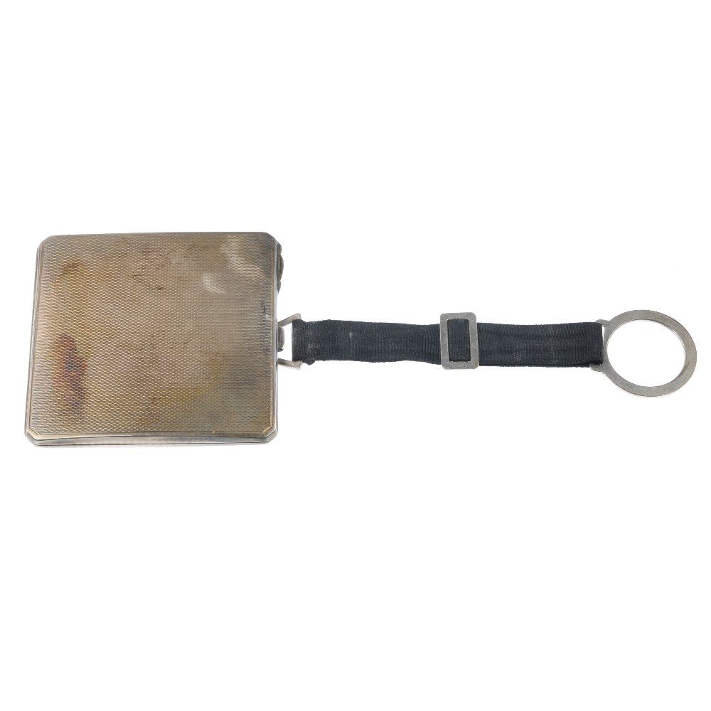 A compact, brooch, single cufflink and pendant mount.: A selection of four items, to include a square-shape textured compact, a silver orange paste and agate dirk brooch, an oval bloodstone cabochon single cufflink and a vacant photo pendant. Two with mar