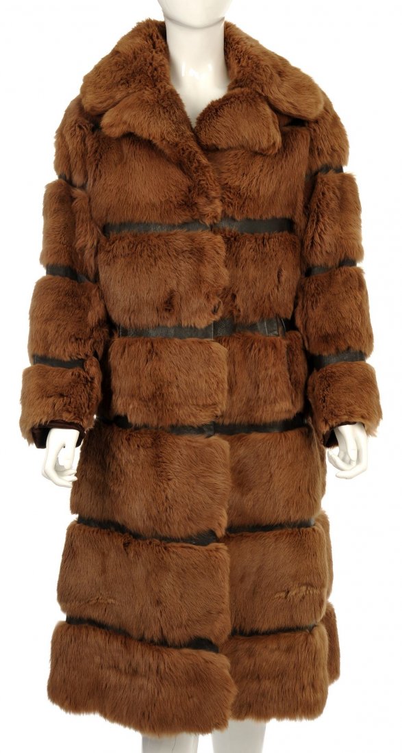 Fur coat with leather banding detail: A red/brown coney fur, long lined coat with a collar and dark brown leather band detailing, with central hook and eye fastenings and two external pockets. Believed to be a size 10.