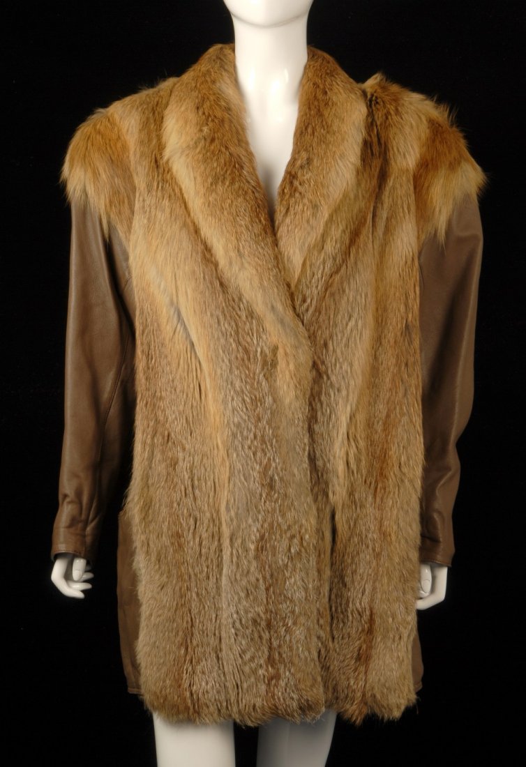 A fox fur and leather coat.: A red and brown fox fur and brown leather lined coat, with two lined pockets, three hook and eye fastenings, brown lining with embroidered flowers, a folded collar and a back belt with button detail. 