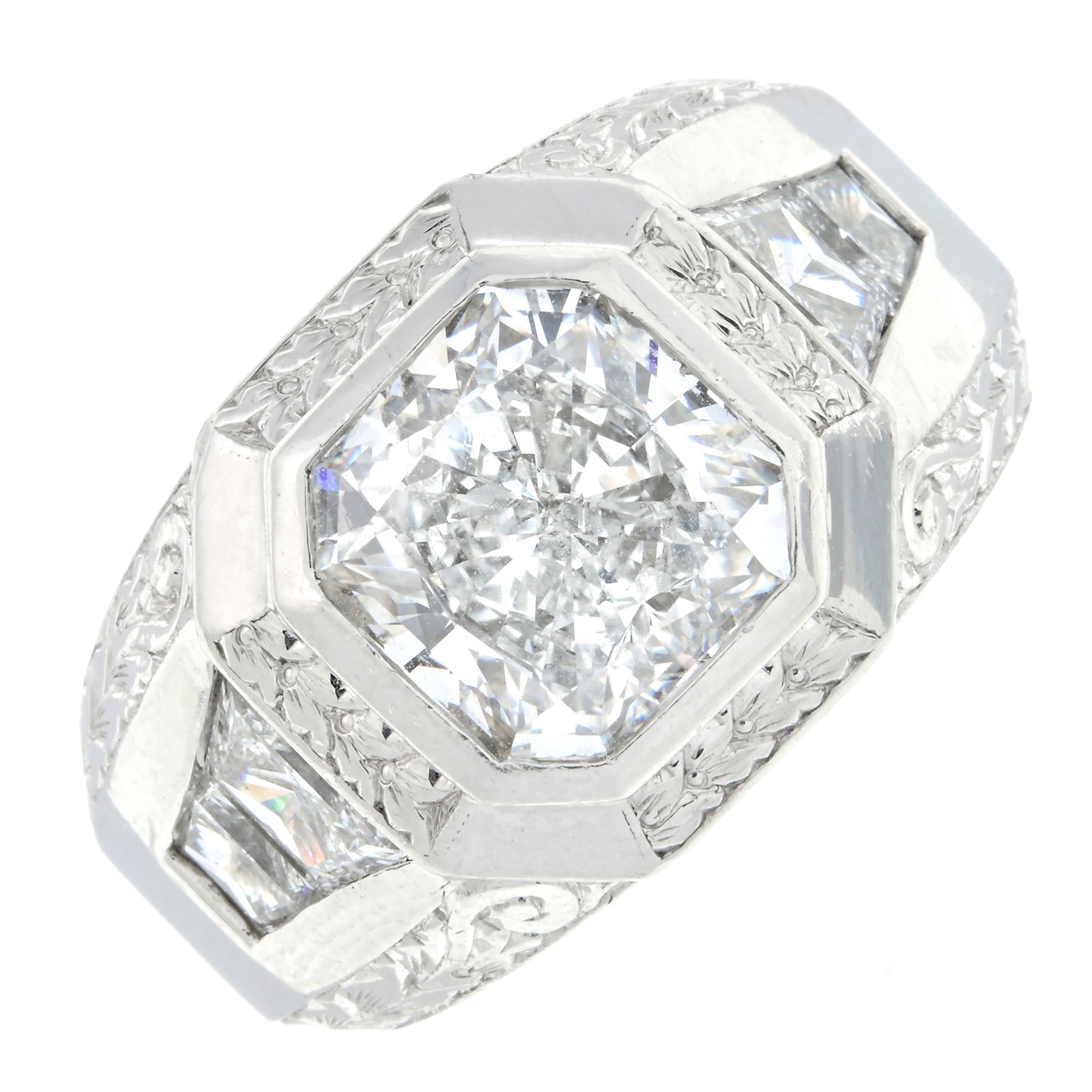 Platinum diamond ring, by Michael Beaudry: With trapezoid-shape diamond line sides and floral engraving.Diamonds estimated G-H colour, VS clarity.Signed Beaudry.?