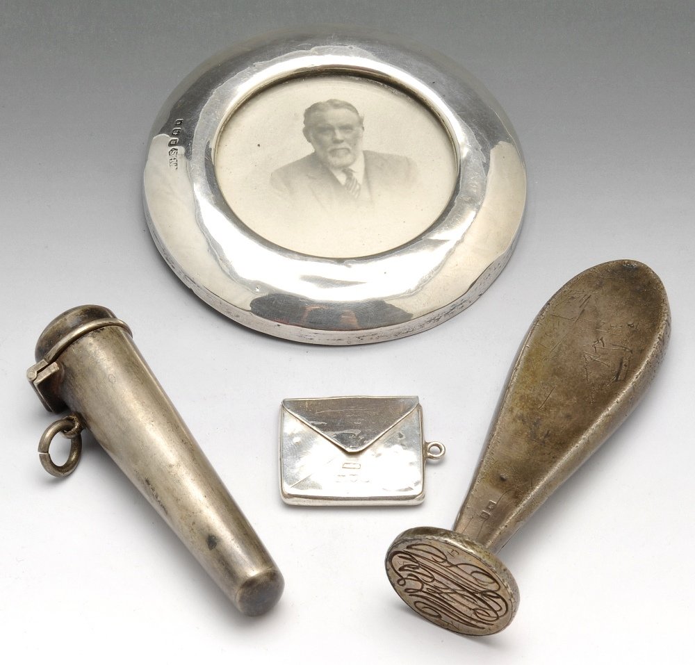 A small collection of silver novelties.: A small collection of silver novelties to include an Edwardian silver stamp case, hallmarked Chester 1903, an early twentieth century miniature silver mounted photograph frame hallmarked London 1918, 