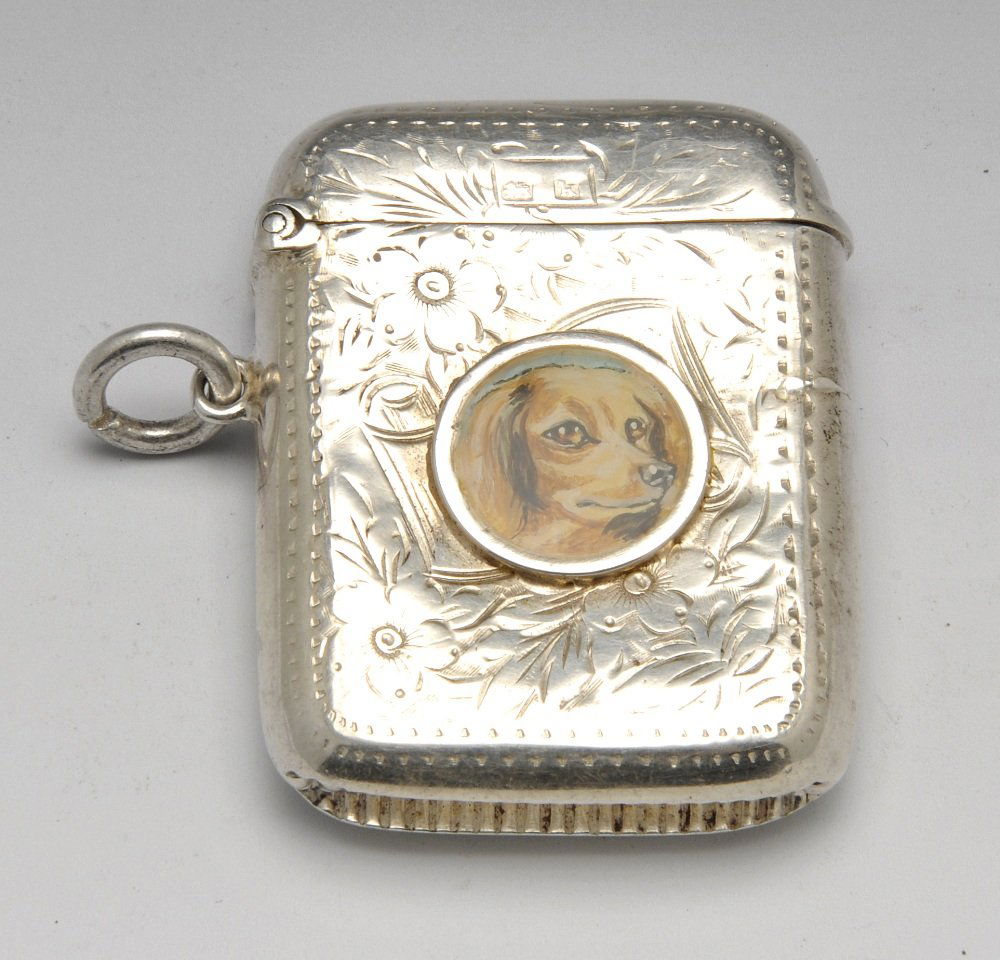 Edwardian silver vesta case.: Edwardian silver vesta case of oblong form and floral engraving, the case front has a later applied circular panel with a painted image of a Spaniel. Hallmarked John Rose Birmingham 1909. Height measu