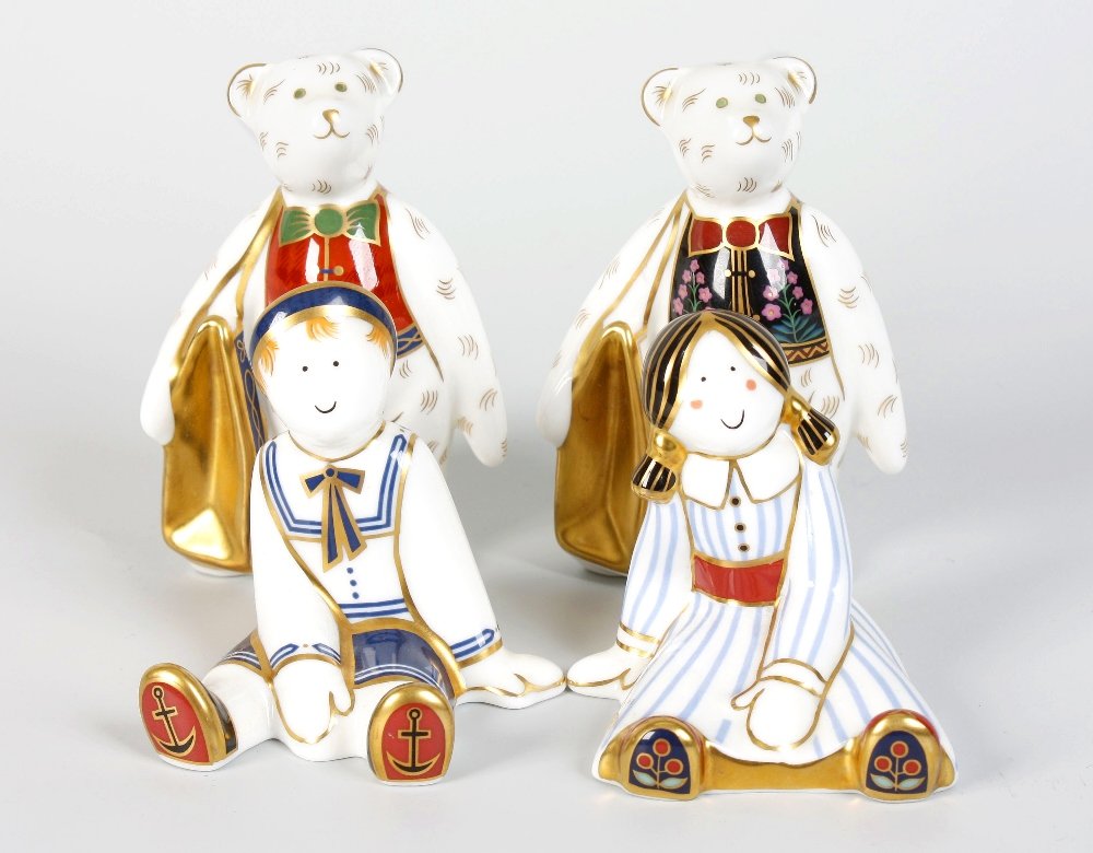 A Royal Crown Derby bone china ornament modelled as a r: A Royal Crown Derby bone china ornament modelled as a ragdoll sailor, together with a similar example modelled as a ragdoll and two other examples modelled as upstanding teddy bears, each carrying a b