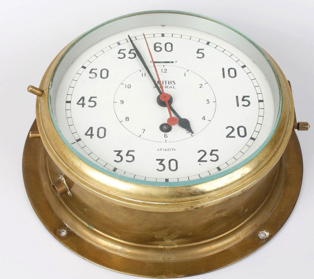 A ship's brass bulkhead clock by Astral of Coventry: A ship's brass bulkhead clock by Astral of Coventry. Having an 8-inch white Arabic dial with inner hour track and centre seconds sweep with red baton, marked "SMITHS ASTRAL AP160714 MADE IN GREAT BRIT