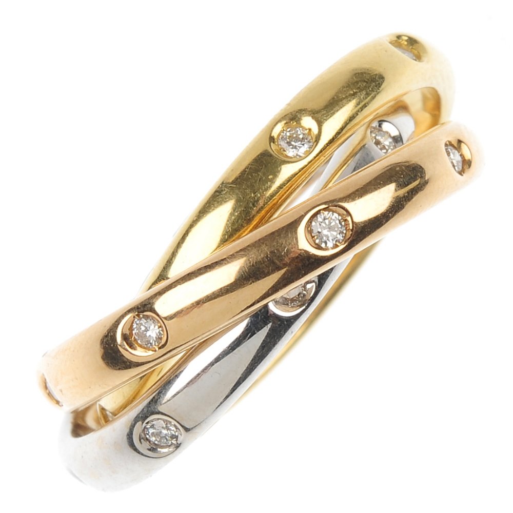 PICCHIOTTI- an 18ct gold diamond triple-band ring.: PICCHIOTTI- an 18ct gold diamond triple-band ring. Designed as three tri-colour interlinked bands, each set at intervals with brilliant-cut diamonds. Signed Picchiotti. Estimated total diamond weight