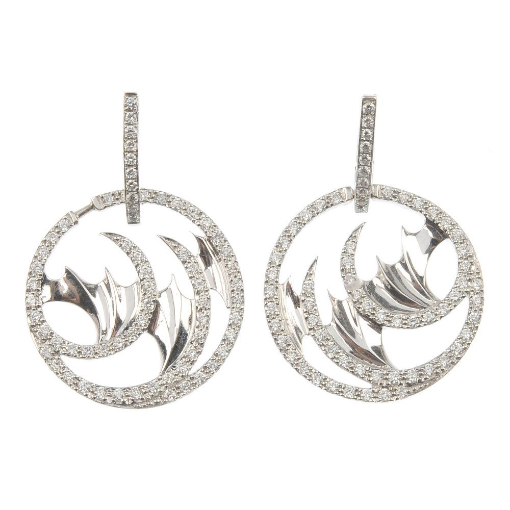 STEPHEN WEBSTER - a pair of 18ct gold diamond ear penda: * STEPHEN WEBSTER - a pair of 18ct gold diamond 'Mini Vortex' ear pendants. Each designed as a brilliant-cut diamond abstract shape, with stylised wing detail, suspended from a similarly-set surmount.