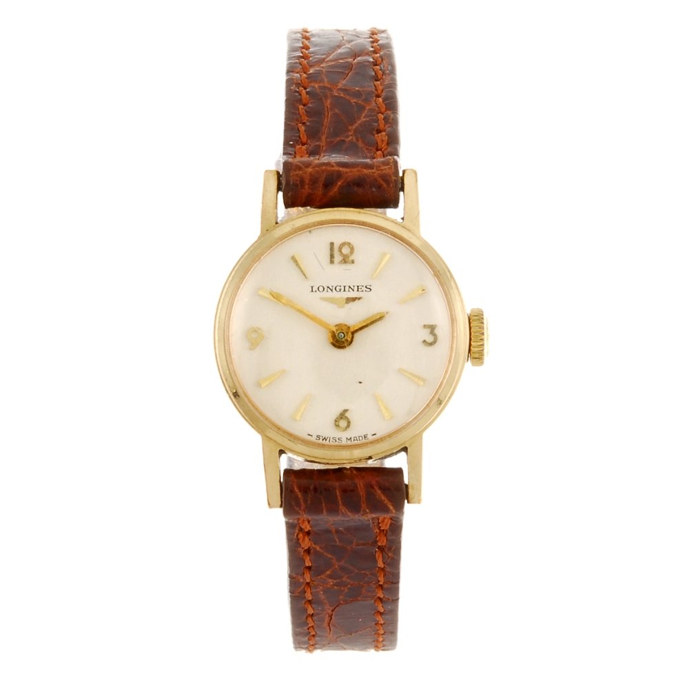 A 9ct gold manual wind lady's Longines wrist watch.: LONGINES - a 9ct gold manual wind lady's wrist watch, the silvered dial with hourly applied gilt batons, quarterly Arabic numerals, circular shaped case, hallmarked London 1971, fitted to a non-origin