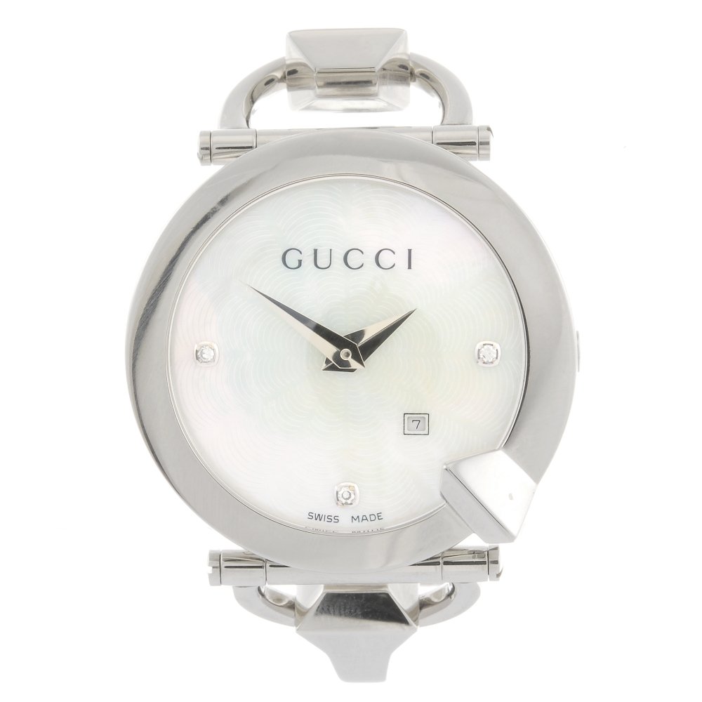 A stainless steel quartz lady's Gucci Chiodo bracelet w: GUCCI - a stainless steel quartz lady's Chiodo bracelet watch, the textured mother-of-pearl dial with diamond dot markers to three, six and twelve o'clock, date aperture positioned to four o'clock, ro