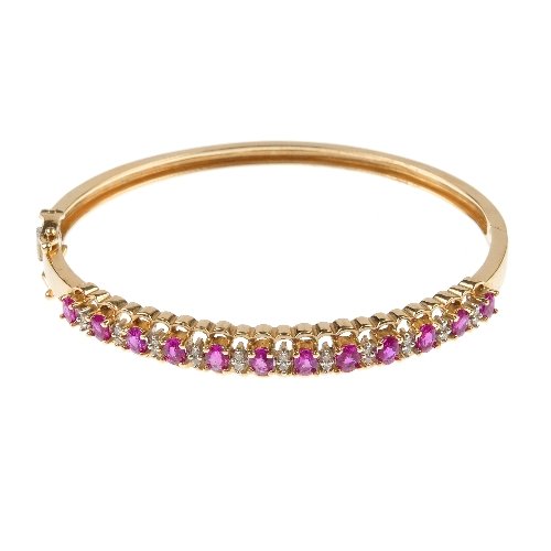 A ruby and diamond hinged bangle.