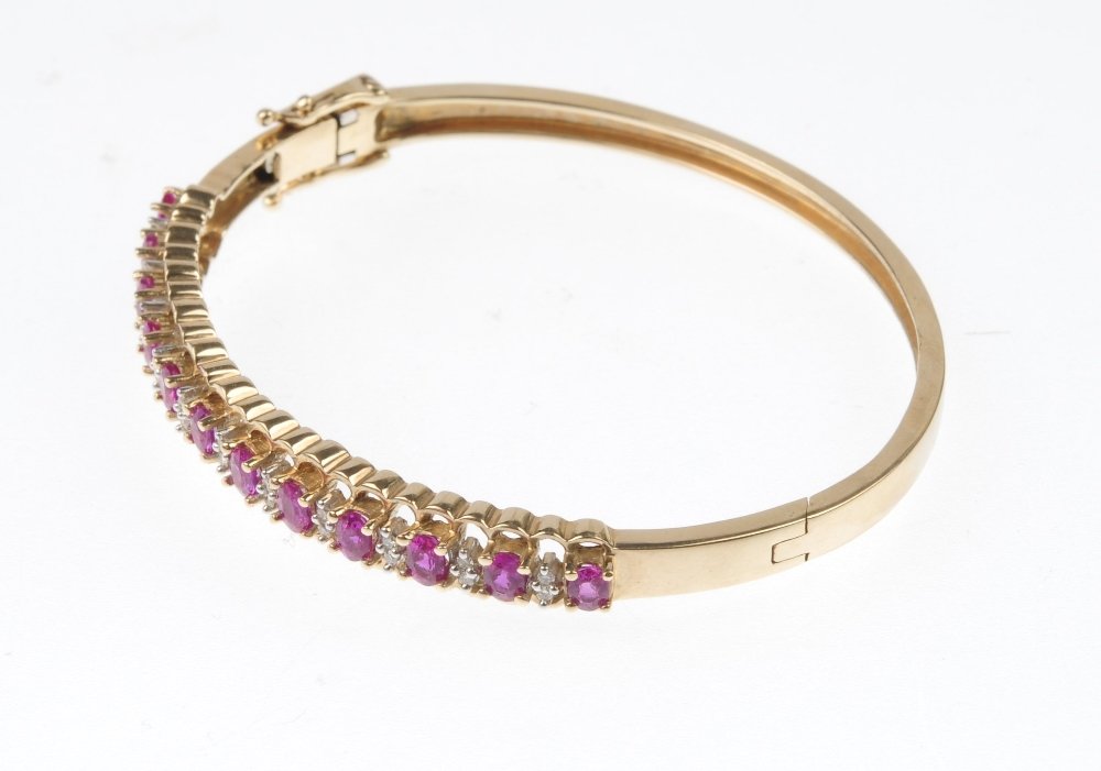 A ruby and diamond hinged bangle. - 2