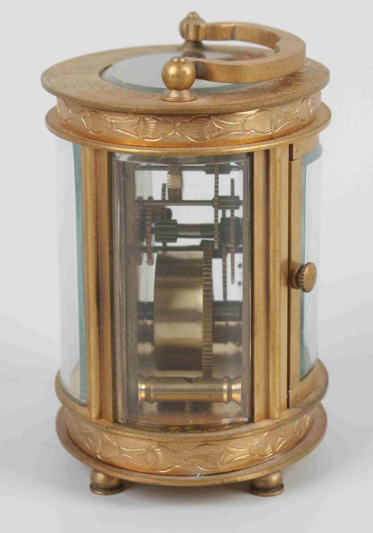An oval 'mignonette' carriage timepiece. Retailed - 2
