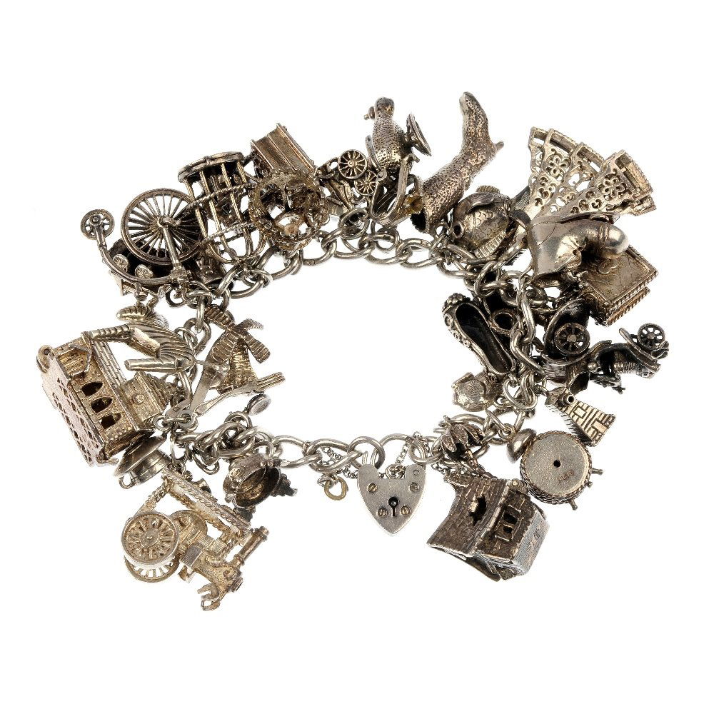 A selection of twelve silver charm bracelets and other : A selection of twelve silver charm bracelets, totalling 146 charms, suspended from curb and trace-link chains, together with a gate-link bracelet and fourteen additional loose charms including a fairy