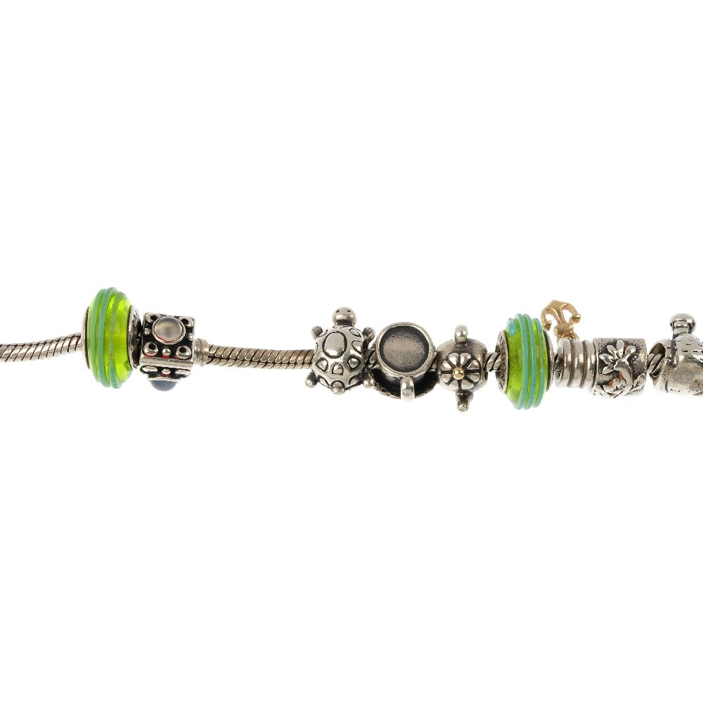 PANDORA - two charm bracelets with charms.: PANDORA - two charm bracelets with charms, each designed as a snake-link bracelet comprising twelve charms. Each bracelet with hallmarks for Edinburgh. Stamped 925, ALE. Length of bracelets 20.5 to 19