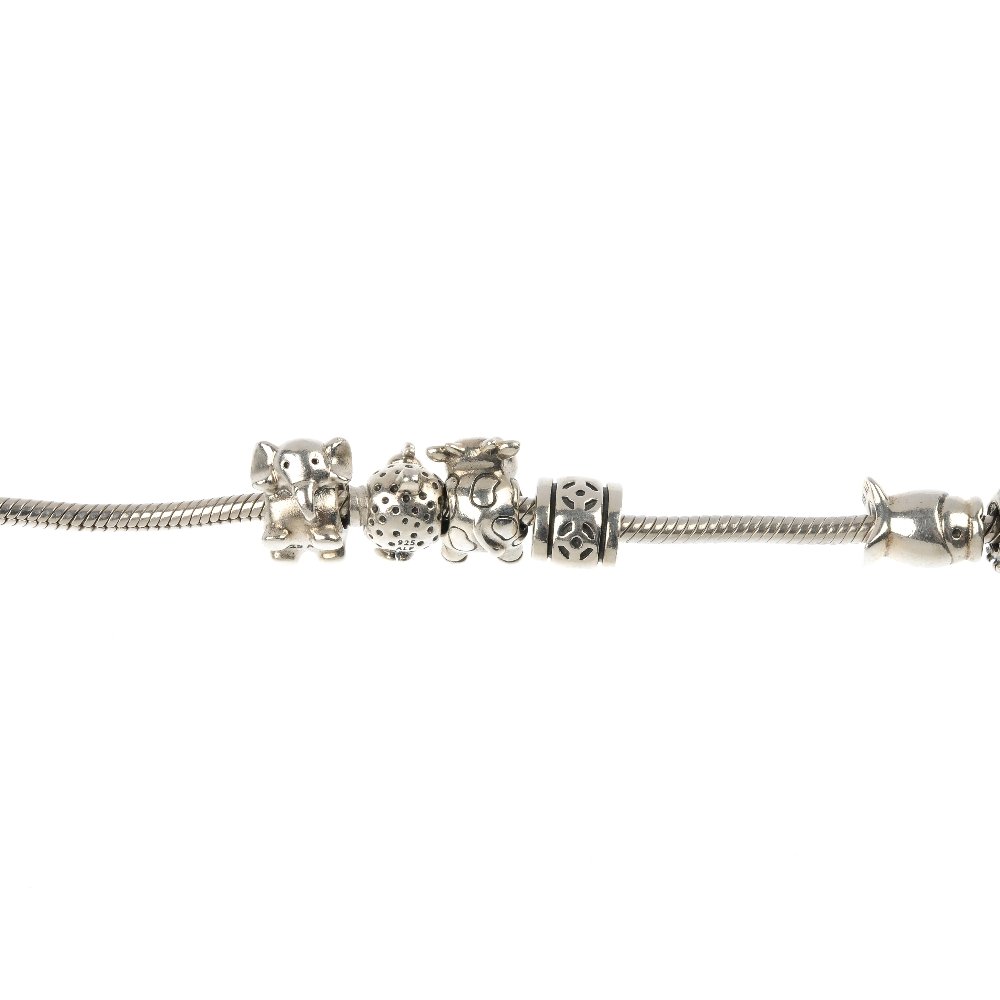 PANDORA - two charm bracelets, one with charms.: PANDORA - two charm bracelets, one with charms, to include a snake-link bracelet comprising eleven charms, together with a similar snake-link bracelet with no charms. Each bracelet with hallmarks for