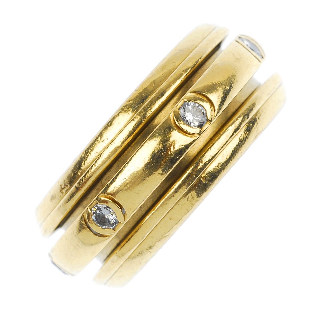 (12677) PIAGET - a diamond ring.: (12677) PIAGET - an 18ct gold 'Possession' diamond band ring. The brilliant-cut diamonds inter-spaced on a pivoting inner band, within a wider band of a raised ridged border. Signed and numbered Piage