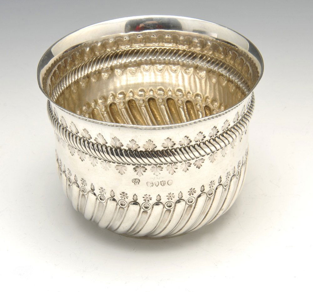 A Victorian silver bowl with George II coin set base.: A Victorian silver bowl with wrythen decoration to the lower body, stamped acorn and foliate borders and George II Halfcrown 1745 set base. Hallmarked Charles Stuart Harris, London 1886. Height measur