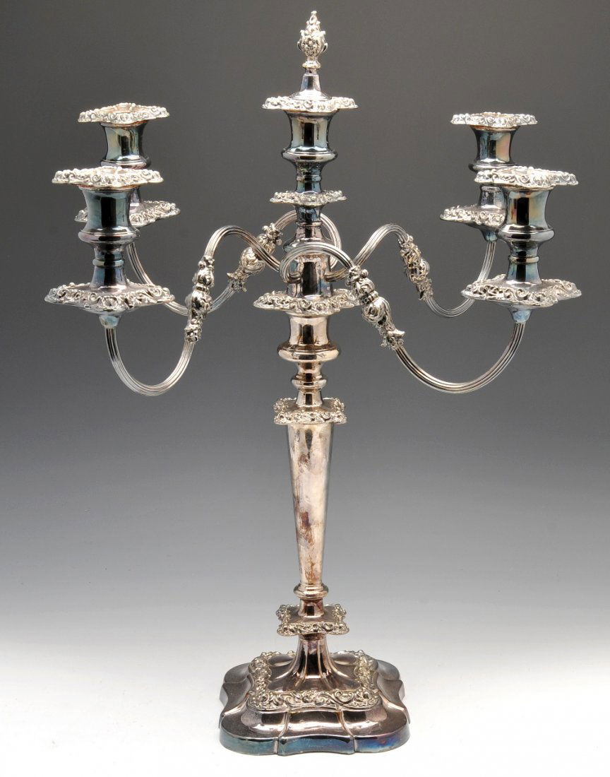 A silver plated candelabrum & lamp base.: A silver plated ornate four branch candelabrum of tapered tiered form with matching twin branch candelabra, standing approximately 19 inches (48 cm) high. Together with a silver plated Corinthian colu