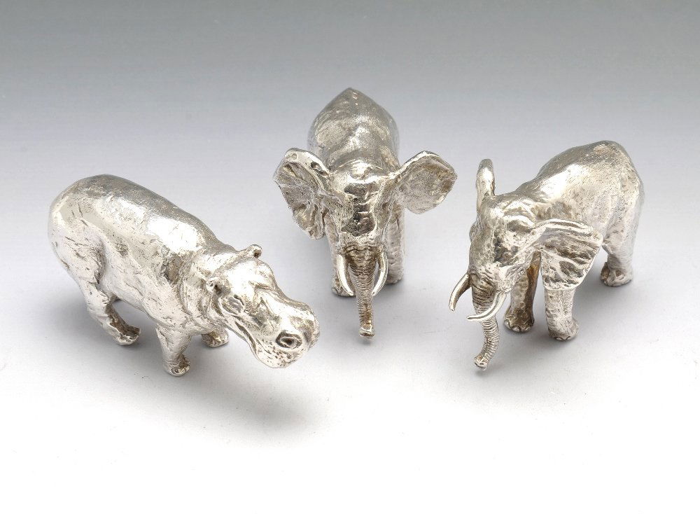 A miniature silver elephants & hippopotamus ornaments.