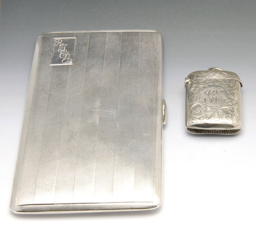 An Edwardian vesta case & 1930's cigarette case.: An Edwardian silver vesta case of slightly curved oblong shape, bright cut engraving with foliate scrolls throughout with central monogrammed panel, hallmarked Thomas Hayes, Birmingham 1903. Together 