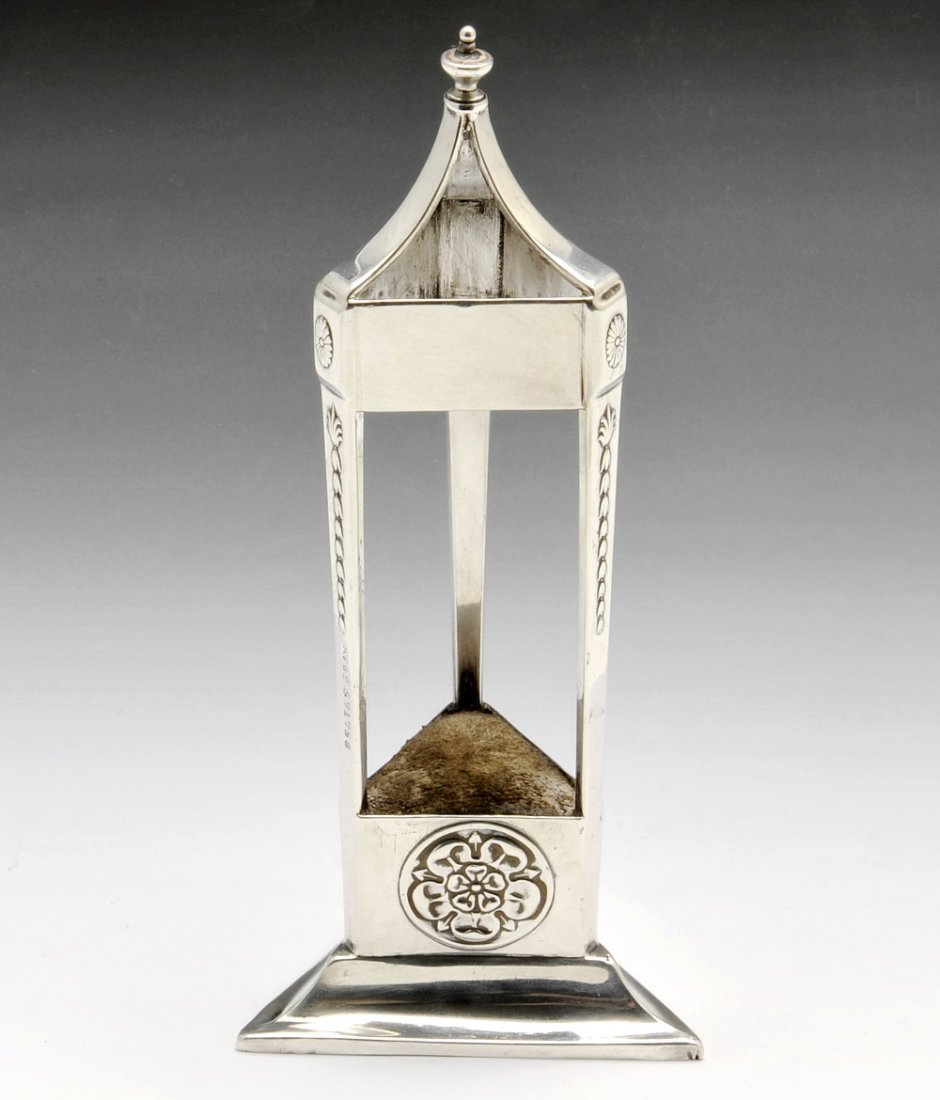 An early 20th century silver mounted pin cushion/hat pi: An early twentieth century silver mounted pin cushion/hat pin stand modelled as a triangular open-work canopy with Tudor Rose decoration. Hallmarked John Round & Son Ltd, Sheffield 1911, registered nu