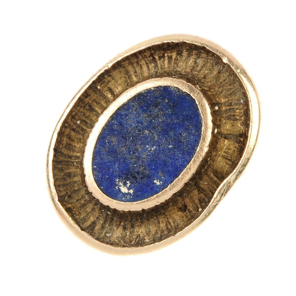 OLE LYNGGAARD - a 1970s Danish 9ct gold lapis lazuli: OLE LYNGGAARD - a 1970s Danish 9ct gold lapis lazuli ring. The oval-shape lapis lazuli panel, within a textured surround, to the plain band. Maker's mark, for Ole Lynggaard. Import marks for London, p