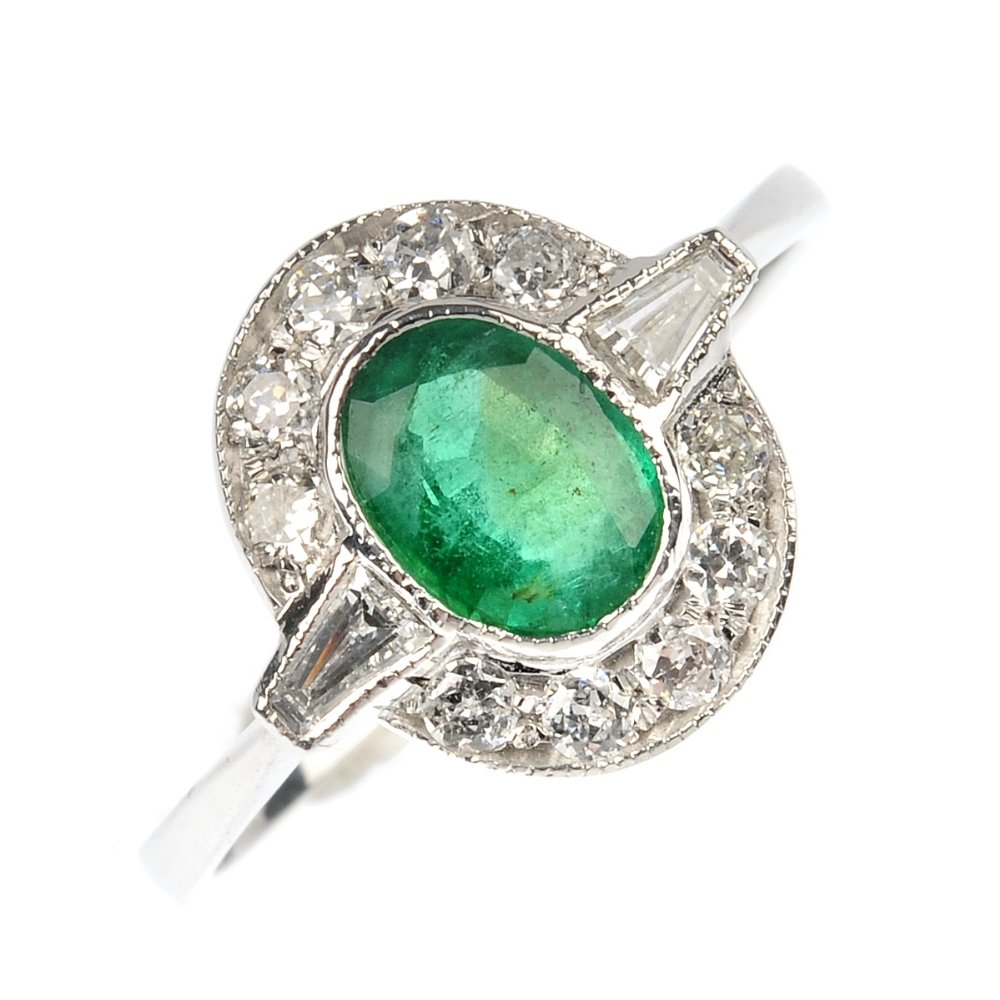 An emerald and diamond ring.