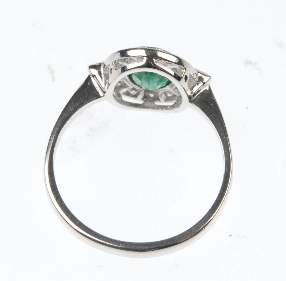 An emerald and diamond ring. - 2