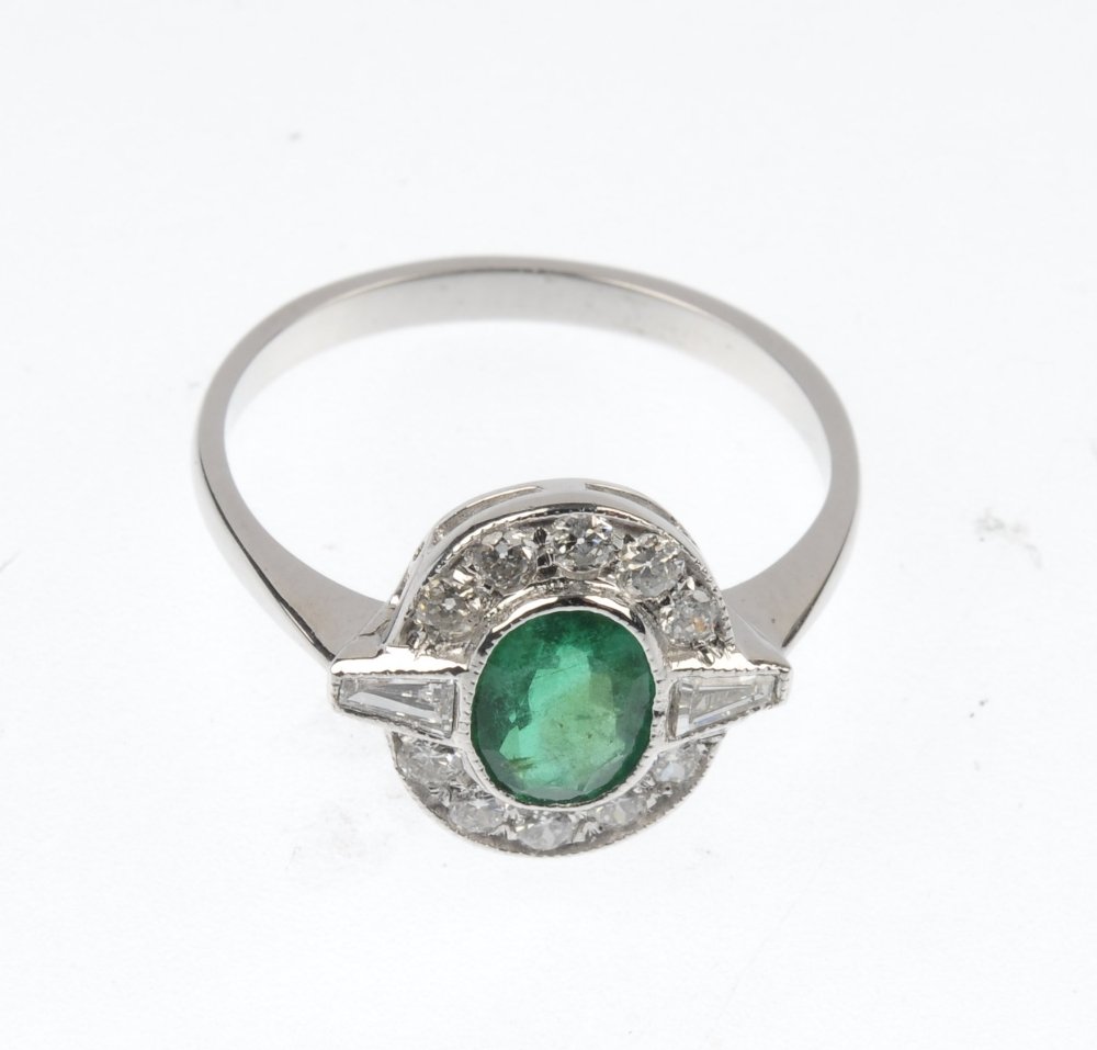 An emerald and diamond ring. - 3