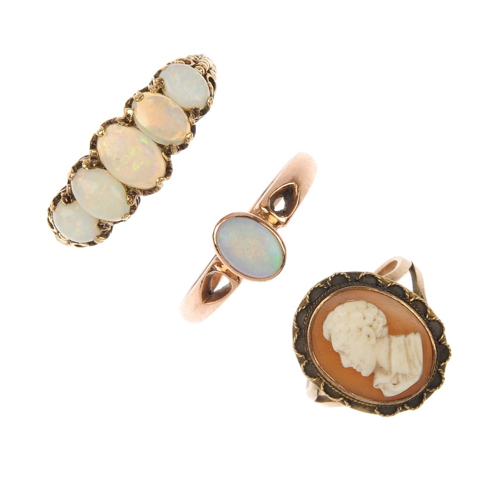 A selection of three gem-set rings.: A selection of three gem-set rings. To include two 9ct gold oval opal cabochon rings and a shell cameo ring. Two with hallmarks for 9ct gold. Total weight 8.4gms.