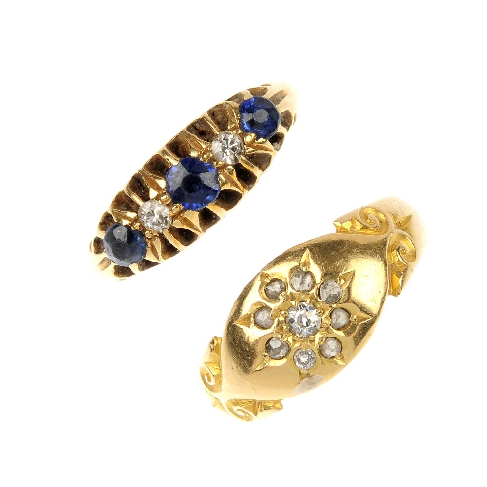 Two late Victorian and early 20th century 18ct gold: Two late Victorian and early 20th century 18ct gold gem-set rings. To include a vari-cut diamond floral cluster ring with scrolling sides, together with a sapphire, blue paste and diamond five-stone r