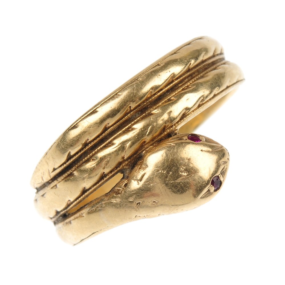 Two 9ct gold snake rings.: Two 9ct gold snake rings. Each designed as a coiled snake, with colourless paste crest or circular-shape ruby eyes. One with hallmarks for London, 1963. Total weight 9.4gms.