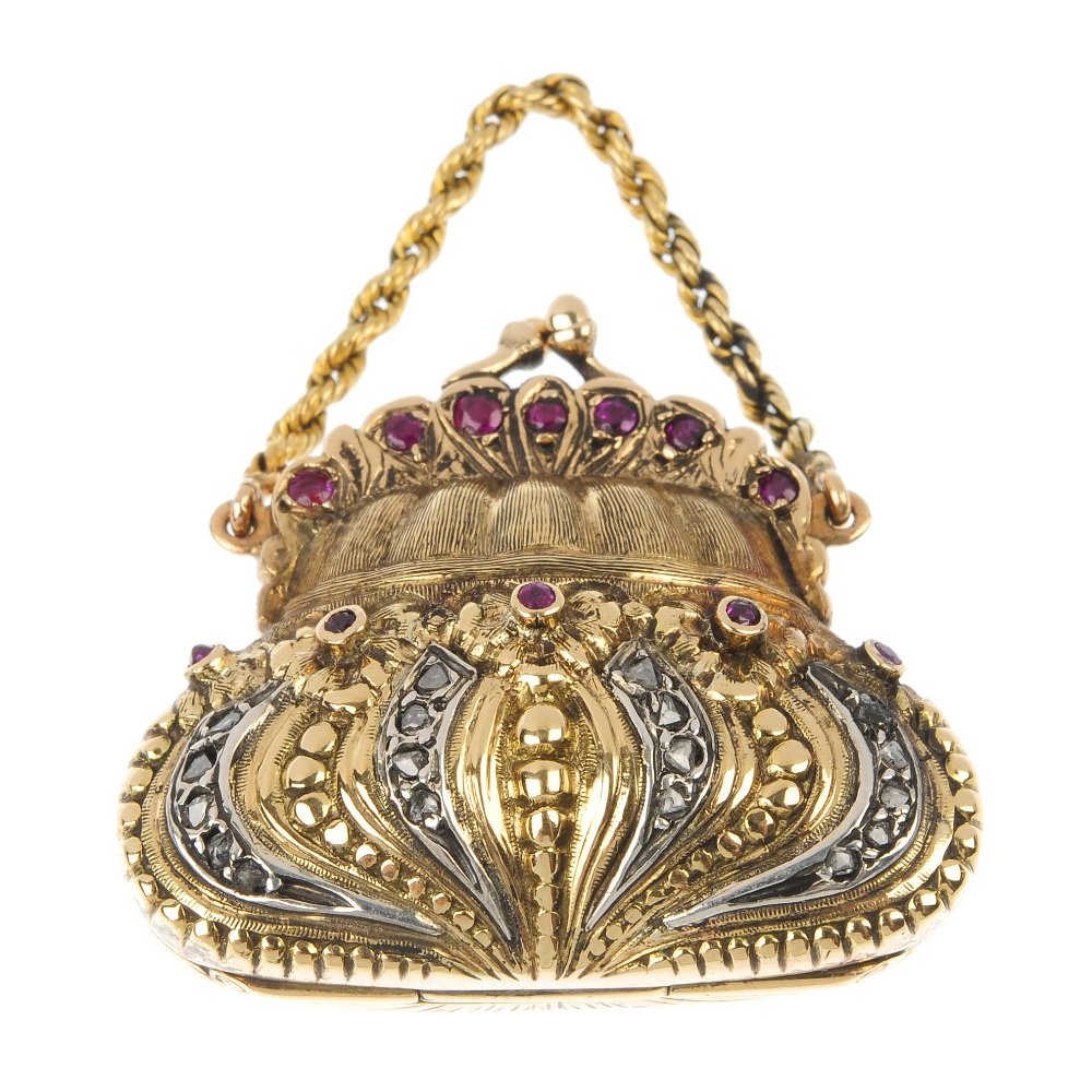 A ruby novelty pendant.: A ruby novelty pendant. Designed as a bi-colour handbag, with rose-cut diamond and circular-shape ruby detail, opening to reveal a watch. Length 3.5cms. Weight 21.6gms.