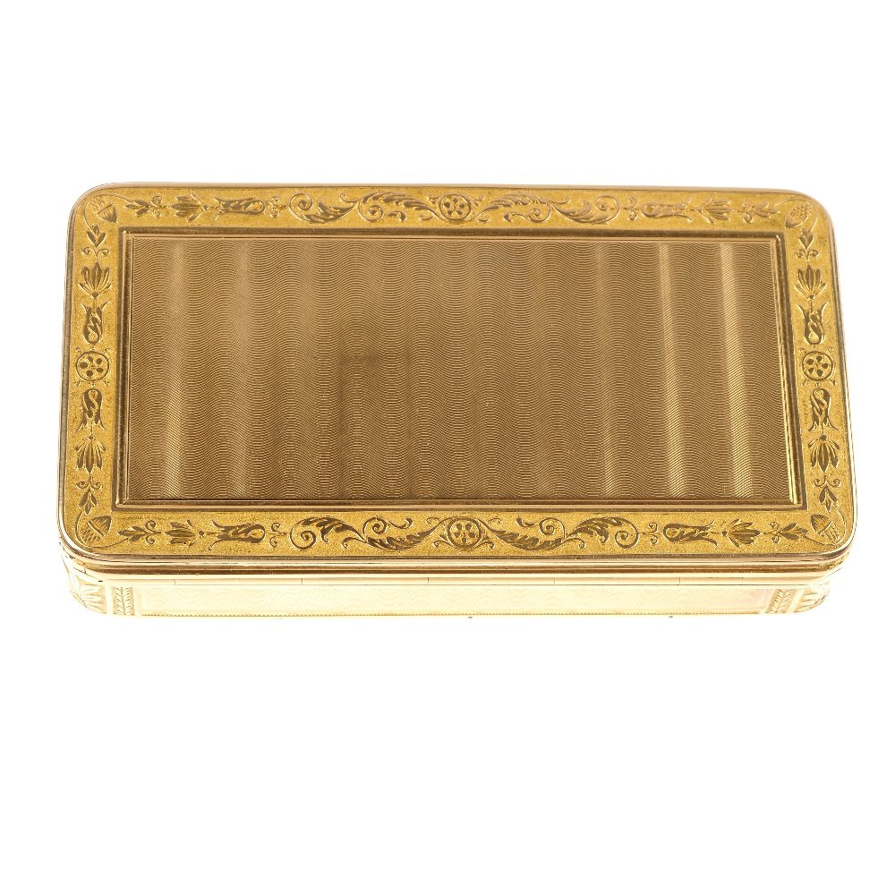 An early 19th century 18ct gold box.: An early 19th century 18ct gold box. Of rectangular outline, with engine-turned and foliate engraved decoration. French assay marks. Length 8.2cms. Weight 95.2gms.