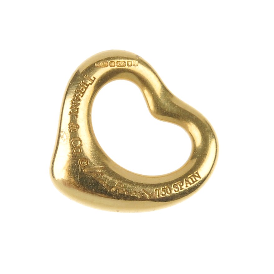 TIFFANY & CO. - an 18ct gold open heart pendant, by Els: TIFFANY & CO. - an 18ct gold open heart pendant, by Elsa Peretti for Tiffany & Co. Signed Tiffany & Co. and Elsa Peretti. Hallmarks for London, 2009. Length 1cm. Weight 1gm.