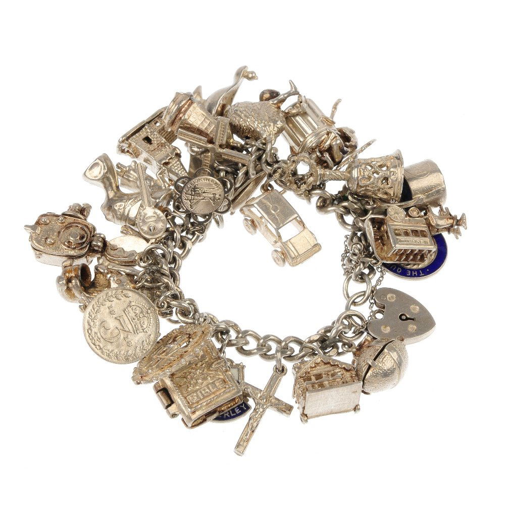 Two charm bracelets.: Two charm bracelets. Comprising a total of thirty-four charms, including a bear eating honey, to the curb and belcher-link chains. Bracelets with silver hallmarks for Birmingham. Length 18cms each. To