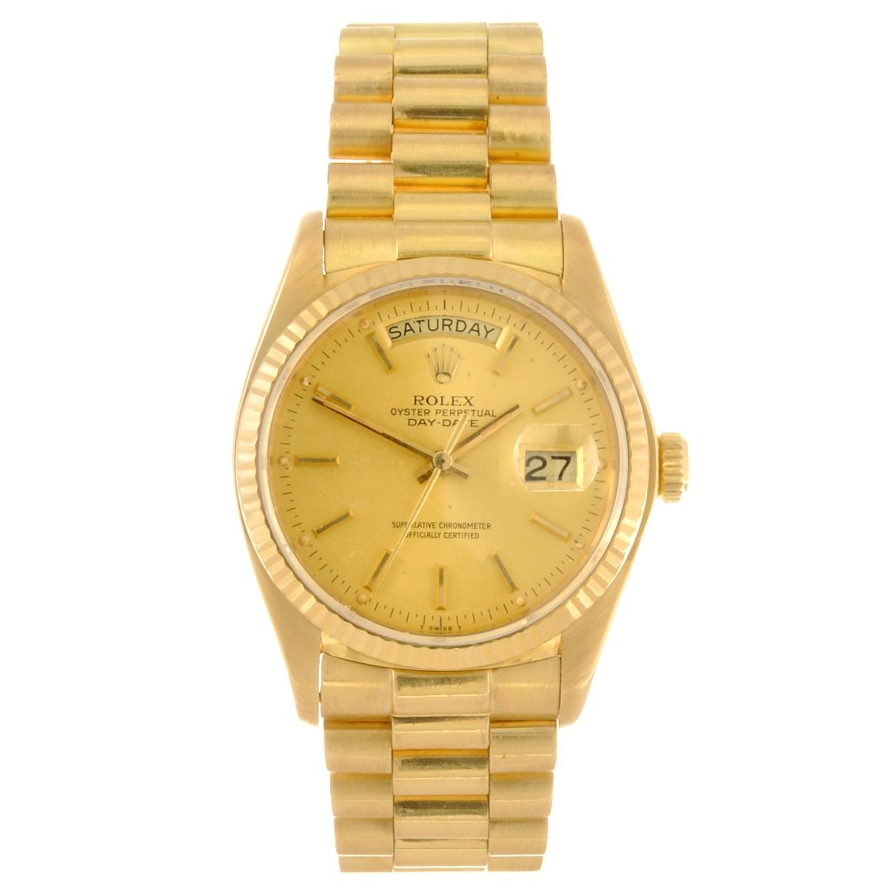 An 18k gold automatic gentleman's Rolex Oyster: ROLEX - an 18k gold automatic gentleman's Oyster Perpetual Day-Date bracelet watch circa 1979, the gilt tone sunburst effect dial with hourly applied batons, day and date apertures set to twelve and t