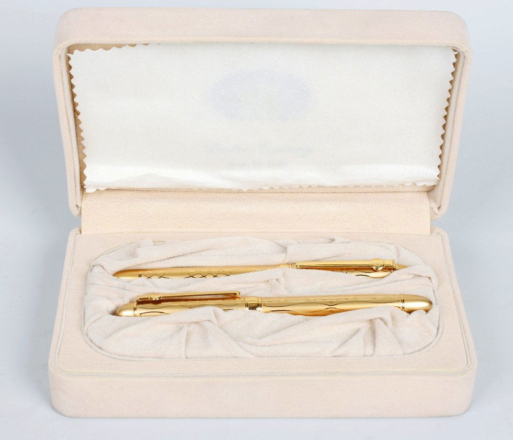 A box containing assorted pens: A box containing assorted pens. To include: a cased Duke Viceroy gold plated fountain pen and ballpoint pen set, cased S. T. Dupont ballpoint pen, cased Zola fountain pen and ballpoint pen, Cross ball