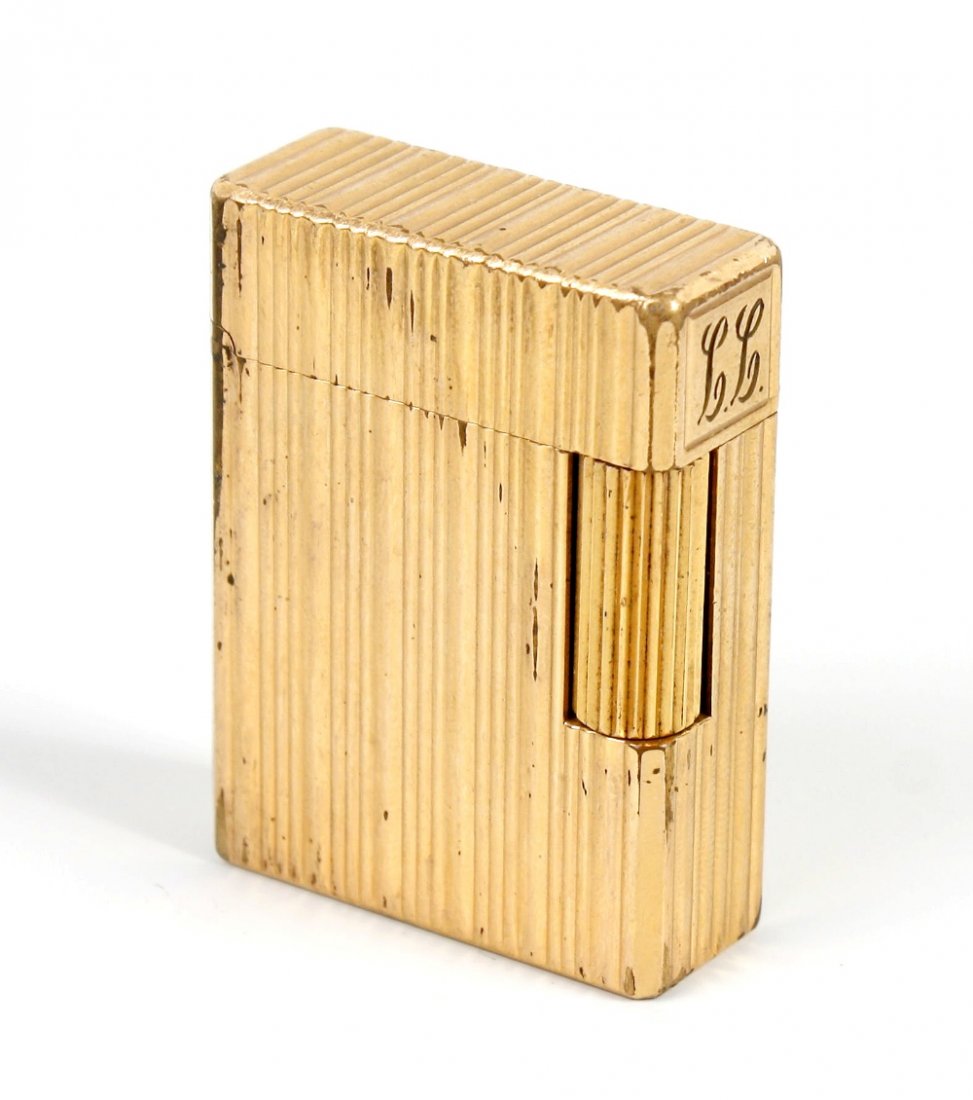 A Dupont gold plated gas lighter: A Dupont gold plated cased gas lighter. the whole of typical hinged rectangular design with engraved line decoration and initials, 1.75" (4.8cm) x 1.5" (3.5cm)