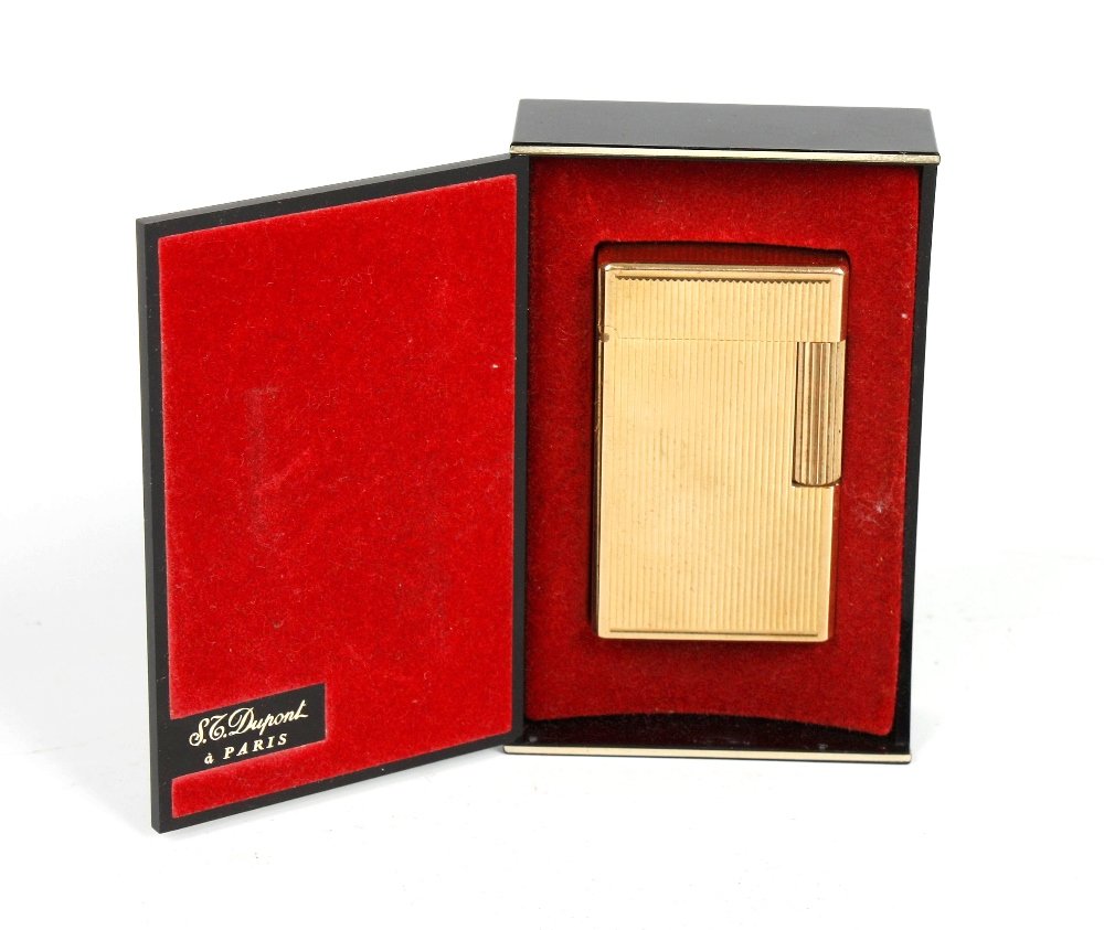A Dupont gold plated lighter.: A Dupont gold plated gas lighter, the whole of typical rectangular design with engraved line decoration, 2.25" (5.8cm) x 1.5" (3.8cm)