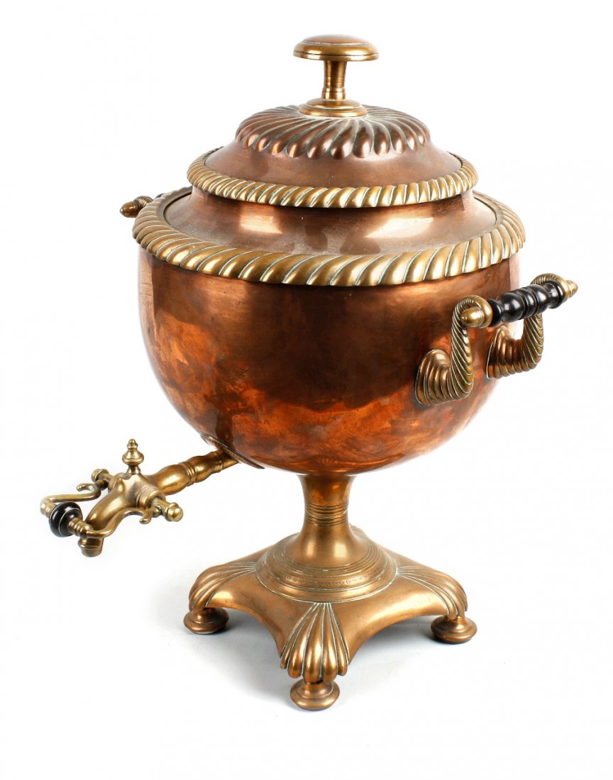 A 19th century copper and brass bodied samouvar of trad: A 19th century copper and brass tea urn or samovar. The scrolled twin carry handles and brass tap fitted with turned wooden insulations. The cover engraved "Presented to Mary Yates by Friends at Fleet