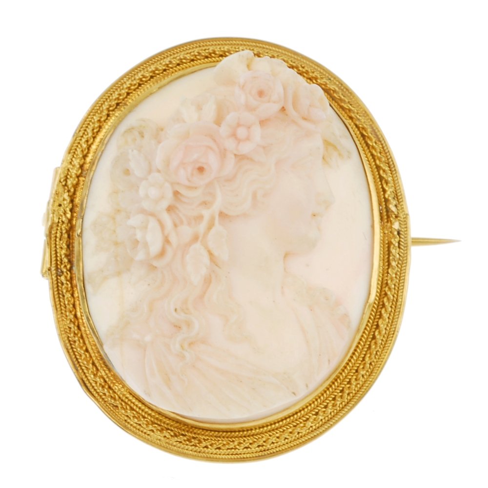 A late 19th century 18ct gold conch shell cameo brooch.: A late 19th century 18ct gold conch shell cameo brooch, of oval-shape outline, carved in high relief, depicting a Bacchante, within a rope-twist border. Length 3.8cms. Weight 13.9gms.