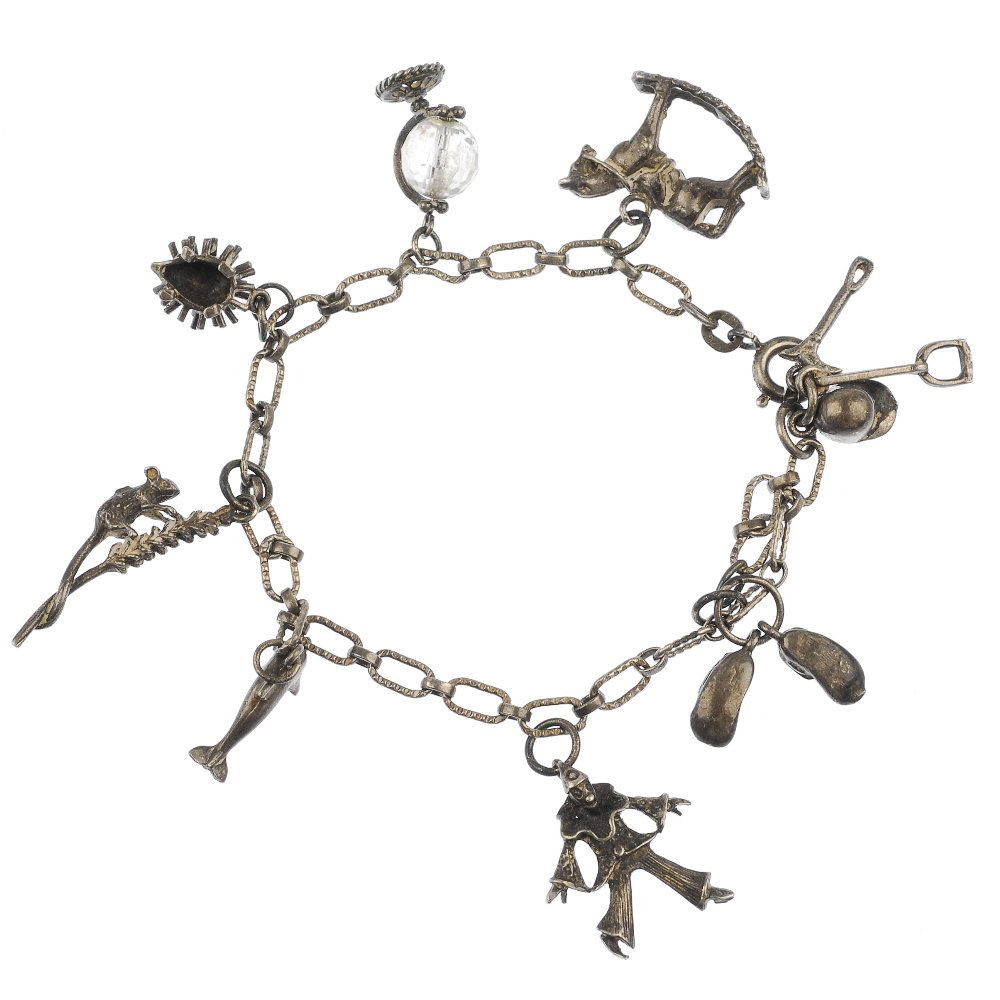 Seven charm bracelets and three curb-link bracelets: Seven silver and white metal charm bracelets and three curb-link bracelets, to include a curb-link bracelet, suspending fourteen charms, to include a donkey and fish. Forty-two charms in total. Some i