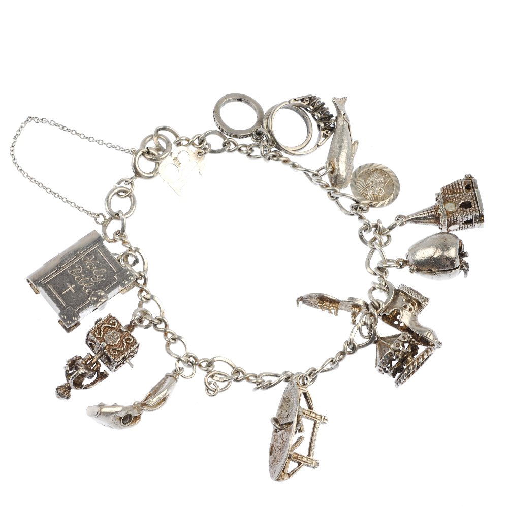Two silver and white metal charm bracelets, two: Two silver and white metal charm bracelets to include a silver curb-link bracelet, suspending twelve charms, to include a church charm with a stanhope of The Lords Prayer. Twenty-seven charms in total