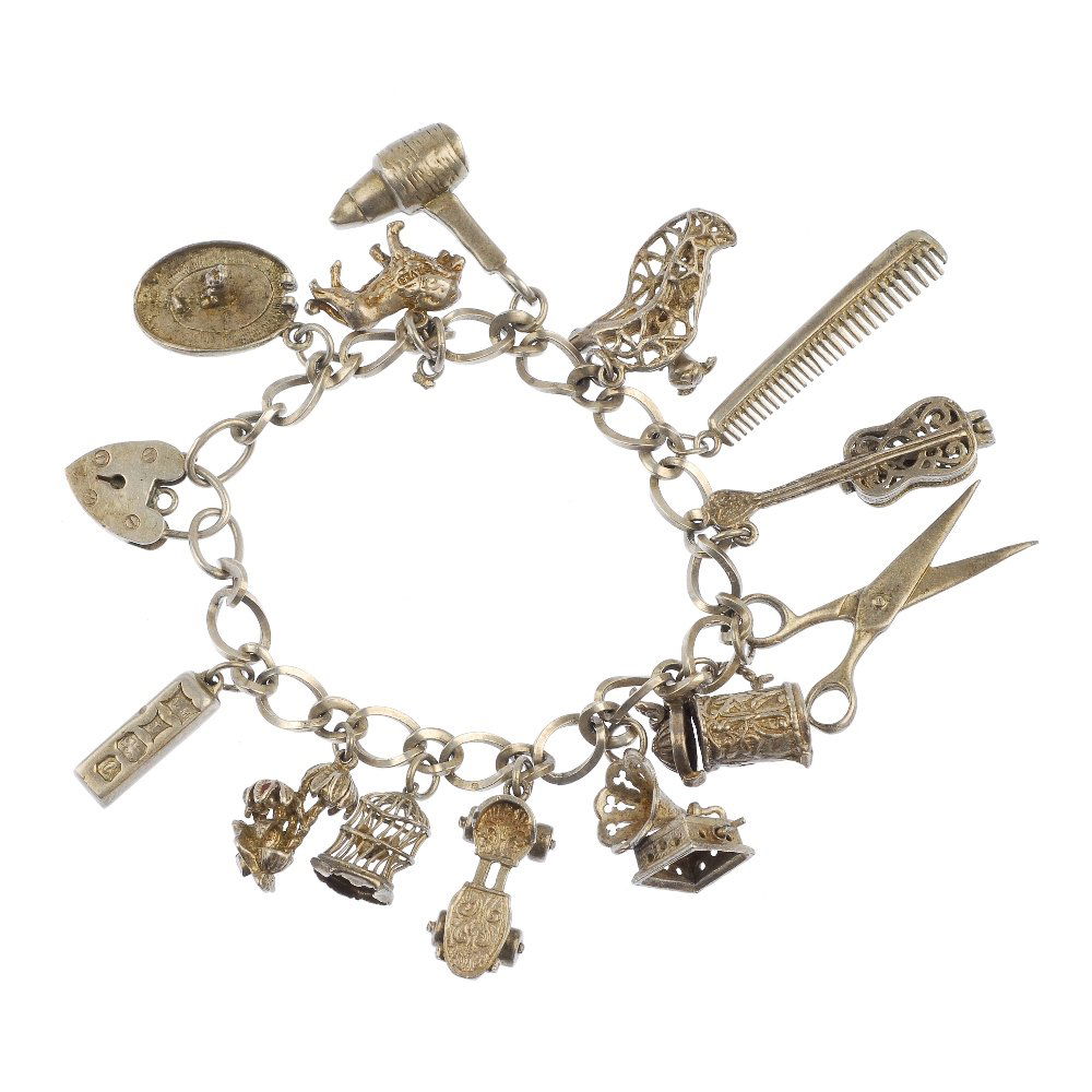 A selection of three silver and white metal charm: A selection of three silver and white metal charm bracelets, to include a silver curb-link bracelet, suspending nine charms, to include a dustbin opening to reveal a cat. Thirty-three charms in total.