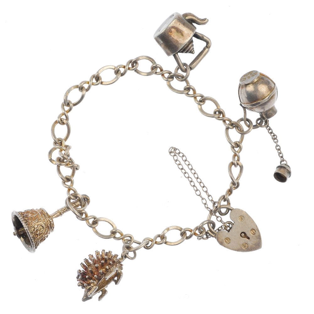 A selection of seven silver and white metal charm: A selection of seven silver and white metal charm bracelets, to include a silver curb-link bracelet, suspending twelve charms, to include a tree house. Approximately fifty-two charms in total. Five br