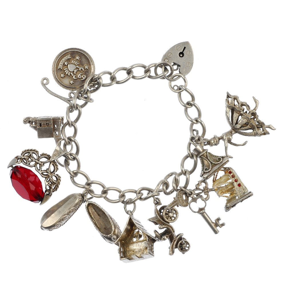 Four silver and white metal charm bracelets.: Four silver and white metal charm bracelets, suspending a total of seventy-five charms, to include a toaster and bell, to the curb and belcher-link bracelets, two with padlock heart clasps. Fifteen ch