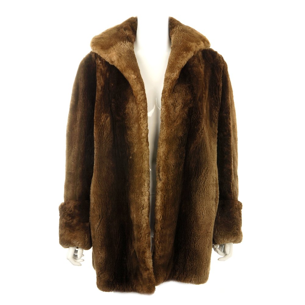 A beaver fur coat.: A beaver fur, three quarter length coat, with wide lapel collar, thick roll back cuffs, two pockets, inner ribbon tie and embroidered initials. Believed to be size 14.