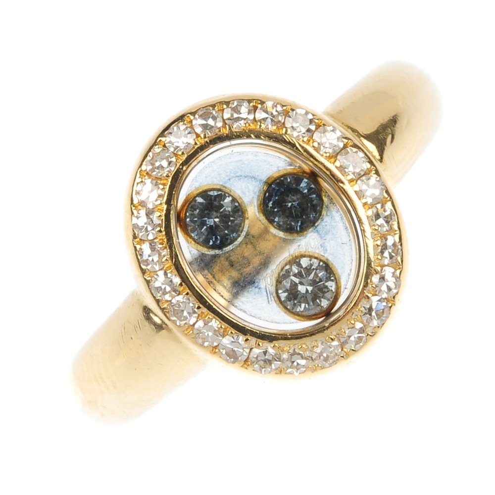 CHOPARD - a 'Happy Diamonds' diamond ring.: CHOPARD - a 'Happy Diamonds' diamond ring. The floating colour blue gem collets, within a single-cut diamond surround, to the plain band. Signed Chopard. Estimated total diamond weight 0.20ct. Convent